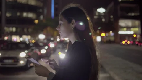 Smiling woman using digital tablet while crossing road in evening Stock Footage 99781063