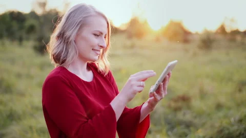 Smiling Woman Using Digital Tablet Outdoors Video stock 148790440