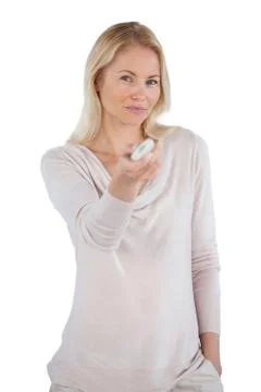 Smiling woman using remote control Stock Photos