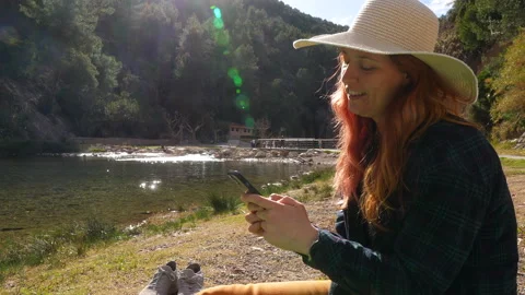 A smiling woman using a smartphone Stock Footage 265104926