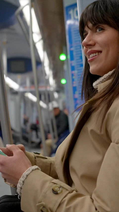 Smiling woman using smartphone while riding public transport Stock Footage 328911519