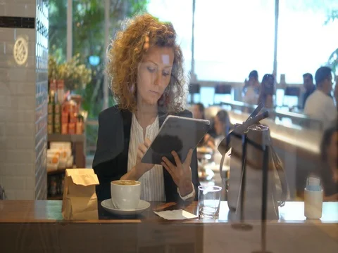 Smiling Woman Using Tablet In Coffee Shop. 4K. Video stock 78498737