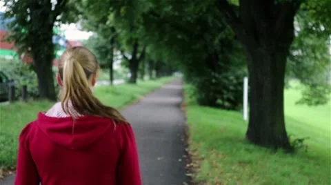 Smiling woman walking in park Stock Footage 8572306