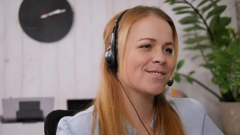 Smiling woman working as customer support operator with headset in a call center Stock Footage 299904294