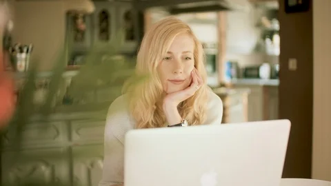 Smiling woman working using her laptop at home Stock Footage 109183637