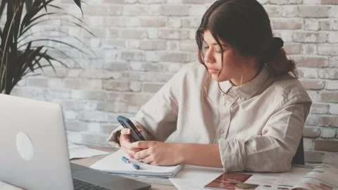 Smiling woman write notes watch webinar study work on laptop, young student  lea 库存影片 196463955