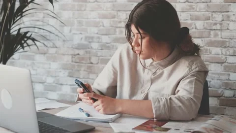 Smiling woman write notes watch webinar study work on laptop, young student  lea 库存影片 196464060