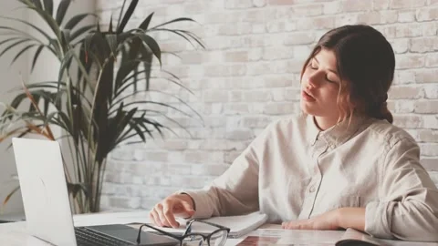 Smiling woman write notes watch webinar study work on laptop, young student  lea 库存影片 196464342