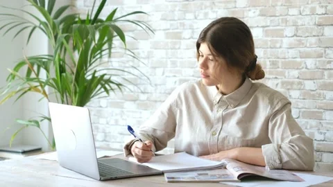 Smiling woman write notes watch webinar study work on laptop, young student  lea 库存影片 196464349