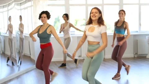 Smiling women learning swing steps at dance class Stock Footage 276952581