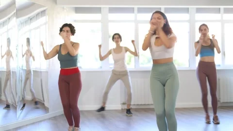 Smiling women learning swing steps at dance class Stock Footage 342126597