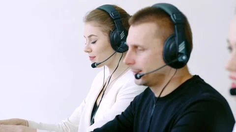 Smiling worker doing her job with a headset while looking at the camera Video stock 61303990