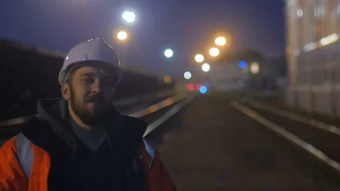 Smiling worker at hignt. He is in hard helmet and reflective jacket. 4k Video stock 83761201