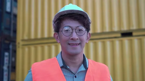 Smiling worker man looking at camera, Engineer in hard hat at cargo Stock Footage 166814667