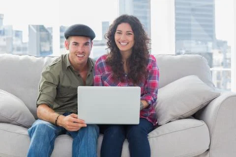 Smiling workers working on a laptop 스톡 사진