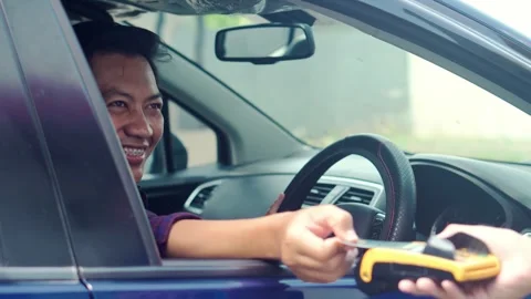 Smiling Young Asian Man In Car Paying With Credit Card At Drive Thru Stock Footage 314653153