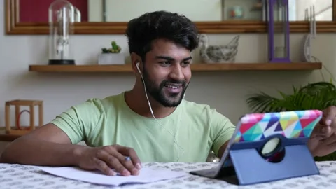 Smiling Young Asian man making conference video call on digital tablet. Видео 154159242