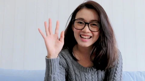 Smiling young asian woman while connection on video call Stock Footage