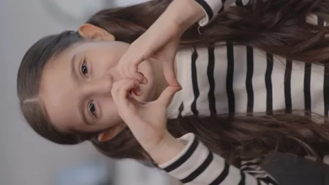 Smiling young beautiful girl showing heart symbol and shape with her hands. Stock Footage 152018053