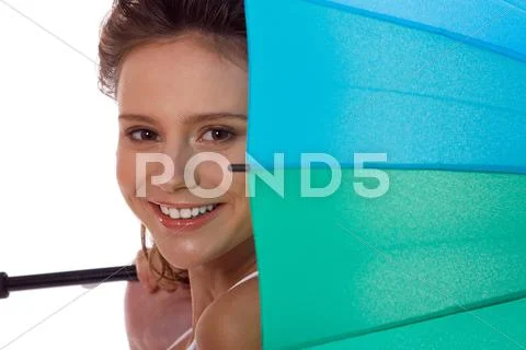Smiling young brunette woman in white blouse with umbrella Stock Photos