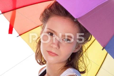 Smiling young brunette woman in white blouse with colour umbrella Stock Photos