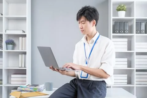 Smiling young businessman checking schedule, planning workday at his office.. Stock Photos