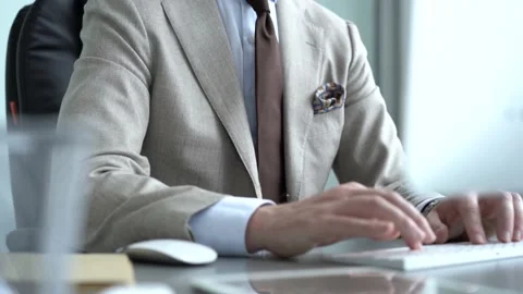 Smiling young businessman typing on computer keyboard Stock Footage 134461113