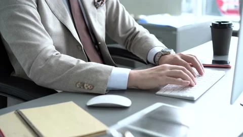 Smiling young businessman typing on computer keyboard 動画素材 134461145