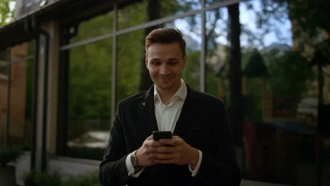 Smiling Young businessman using helpful mobile apps for business time management Stock Footage 131602505