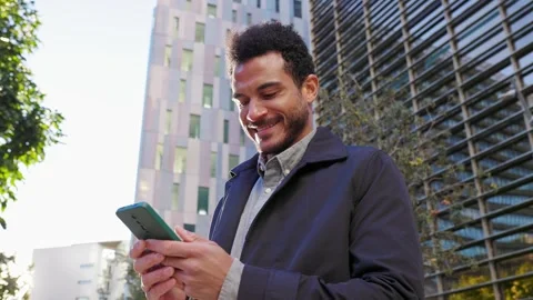 Smiling young businessman using smartphone in city Stock Footage 345094763