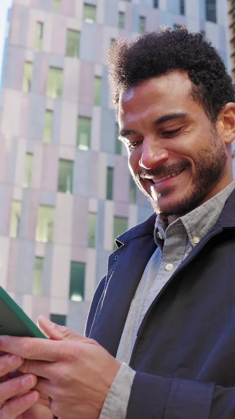 Smiling young businessman using smartphone in city Stock Footage 345247166