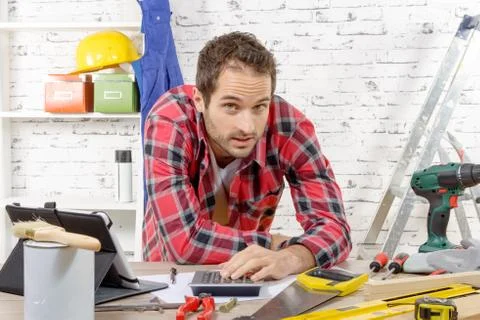 Smiling young carpenter in his workshop Stock Photos