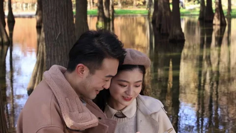 Smiling young cheerful active couple enjoying time in farm park, family good Stock Footage 336564629
