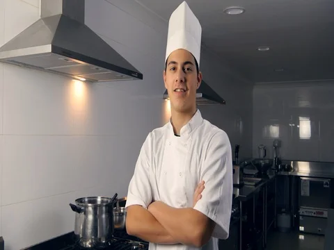 Smiling young chef portrait working as a professional cook Stock Footage 75432944