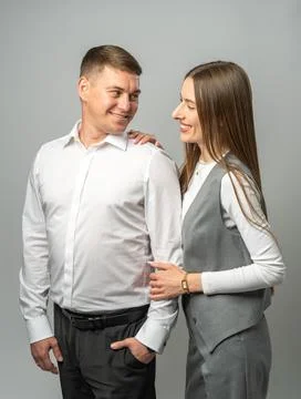Smiling young couple in studio looking at each other with love and warmth. Bo Stock Photos
