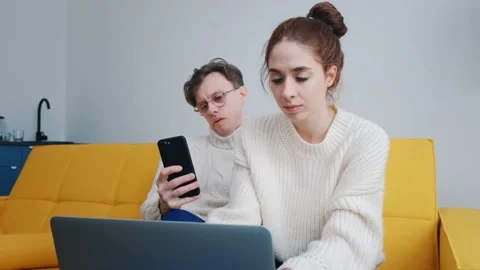A smiling young couple using laptop at home indoor Stock Footage 170379168