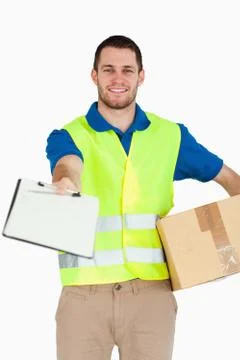 Smiling young delivery man with packet asking for signature Stock Photos
