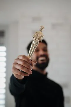 Smiling young engineer holding robotic arm. Stock Photos