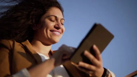 Smiling young entrepreneur working using tablet outdoors Stock Footage 131566162