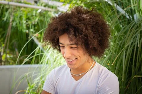 Smiling young ethnic guy 20 years old, dressed in casual clothes, works on .. 스톡 사진