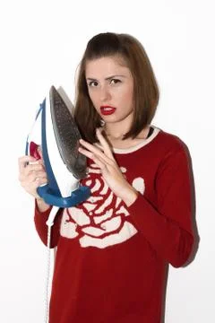 Smiling young girl ironing with iron isolated Stock Photos