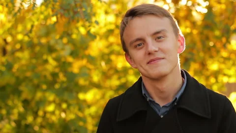 Smiling young guy in autumn Stock Footage 96746239