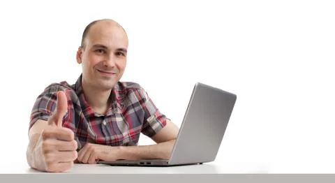 Smiling young guy using laptop computer. Stock Photos