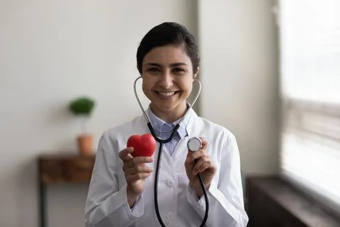 Smiling young indian cardiologist reminding regular checkup meeting. Stock Photos