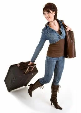 Smiling young lady pulling her luggage Stock Photos