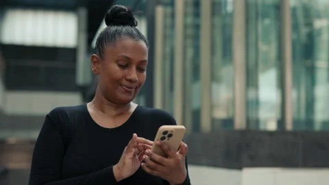 Smiling Young Lady Standing Outside and Using Smartphone for Sport Purposes. Stock Footage 310537984