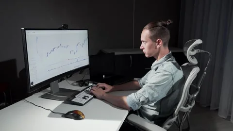 Smiling young male IT programmer focused on his project at night Stock Footage 311655268