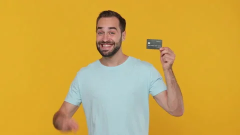 Smiling young man 20s in basic casual blue t-shirt posing isolated on yellow Video stock 148291345