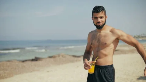 Smiling young man with beard posing for camera on a summer day at beach Stock Footage 79181739