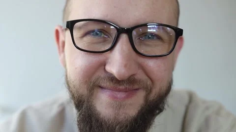 Smiling young man with beard wearing glasses Video stock 242720366